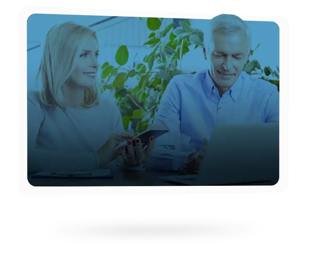 Happy senior couple with benefit card and tablet